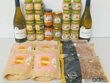 many bottles of wine, nuts, and other food items on the table