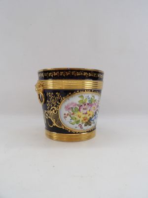a black and gold vase with flowers on it
