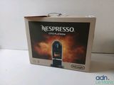 a box of nespresso coffee machine sitting on a table
