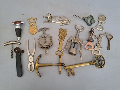 a lot of different types of wine openers on the table