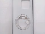 a white box with a charger and a cable in it