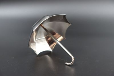 a silver umbrella that is sitting on a table