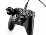a close up of a video game controller on a white surface