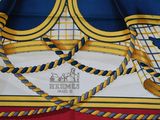 a close up of a blue and yellow scarf with a red border