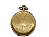 a gold pocket watch with a floral design on it