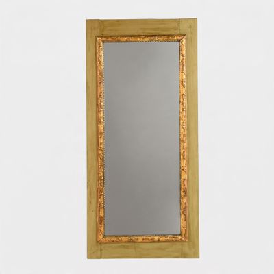 an image of a gold framed mirror against a white wall