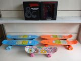 several skateboards are lined up on a shelf in a store