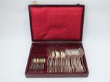 a red case with silverware in it on a white surface