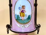 a purple vase with a picture of a little girl on it