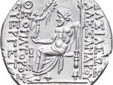 a close up of a silver coin with an image of a man holding a sword