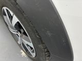 a close up of a tire on a white car