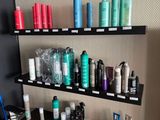 many different types of hair products displayed on the shelves