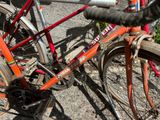 a red bicycle parked on the side of the road