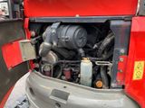 a red truck with a large engine in the back of it
