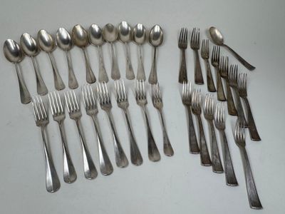many forks and spoons laid out on the table