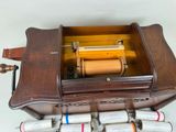 a wooden box with a musical box inside of it