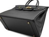 a black leather handbag on a white background
