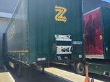 a semi truck that is parked in front of a building