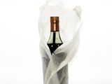 a bottle of wine wrapped in a plastic bag