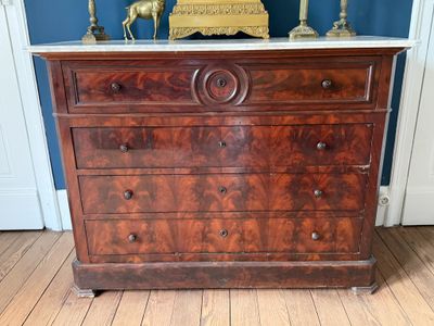une commode avec un plateau en marbre dans une pièce aux murs bleus