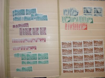 two pages of paper with stamps on them on a table