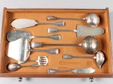 a wooden tray with silverware and spoons in it