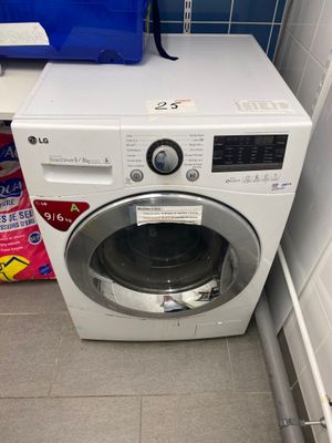 a washer and dryer in the corner of a bathroom