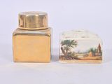 two salt and pepper shakers sitting next to each other