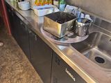 a kitchen with a sink and a lot of wine glasses on the counter