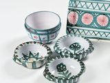 four bowls and a box sitting on a table
