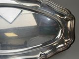 a silver tray with a mirror in it on a table