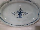 a blue and white plate with a flower design on it