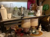 a shelf with dishes and cups on it in a kitchen