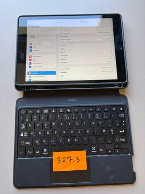 a tablet computer sitting next to a laptop computer on a table