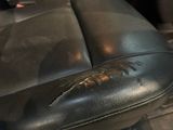 a close up of a car seat with a broken arm rest