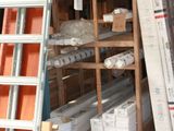boxes and ladders are stacked up in a storage area of a warehouse