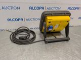 a yellow and black machine sitting on top of a metal table
