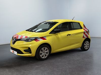 the small yellow car is parked in a large room