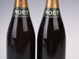 two bottles of moet champagne on a white background
