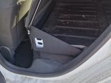 the interior of a car with the door open and the passenger seat down