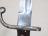 a knife that is on top of a metal pole
