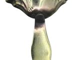 a silver vase with a flower on it on a white background