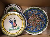three plates in a box with a painting of a man and a woman on them