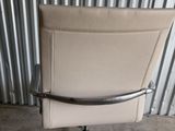 an image of a chair that is sitting in front of a metal wall