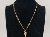a necklace with a cross on a mannequin neck