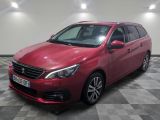 a red car is parked in a room with a checkered floor