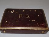 a small brown box with writing on it on a table