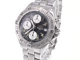 a silver watch with a black face on a white background