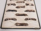 a lot of silver spoons in a case on a table