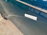 a blue car parked on the side of the street